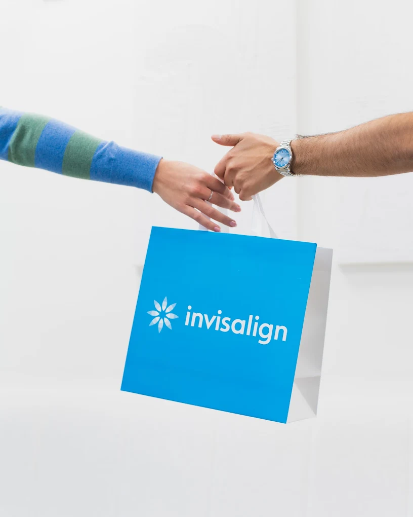 Patient with their Invisalign starter kit at Cobham Dental