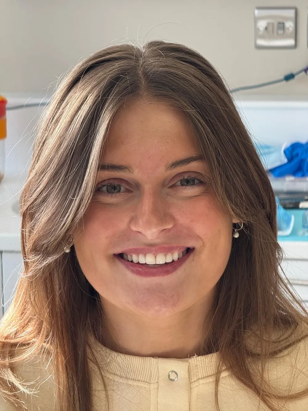 The same patient's smile after Invisalign, with the front teeth aligned